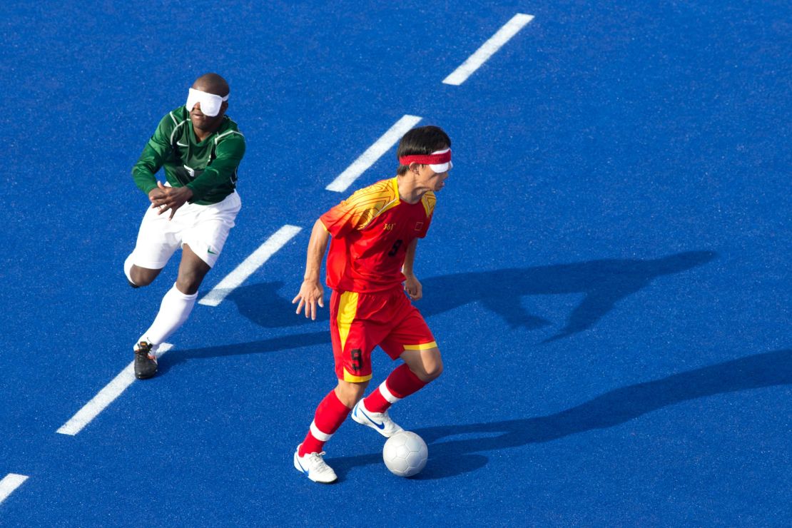 Visually impaired footballers play by locating the ball and each other through sound.