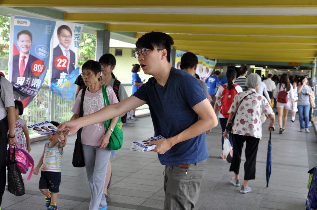 Edward Leung hands out leaflets for Youngspiration candidate Baggio Leung in the New Territories East constituency.