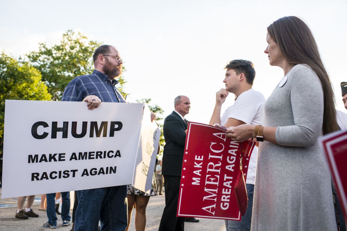 A supporter confronts a protester outside of a rally for Donald Trump at in Akron, Ohio on August 22, 2016.