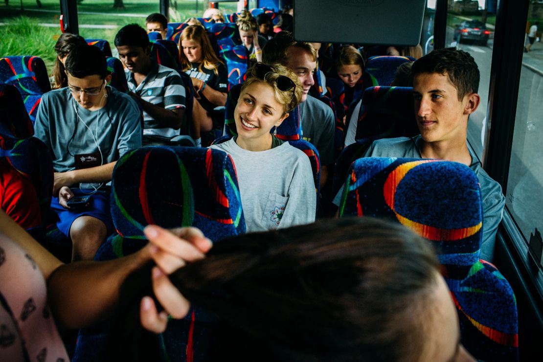 Campers and counselors ride a bus headed for Outward Bound, where they will participate in trust-building exercises.
