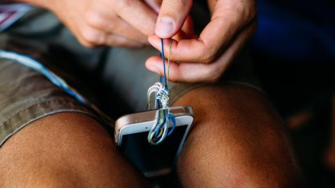 Patrick O'Hagan makes a friendship bracelet using a technique he learned from a fellow camper.