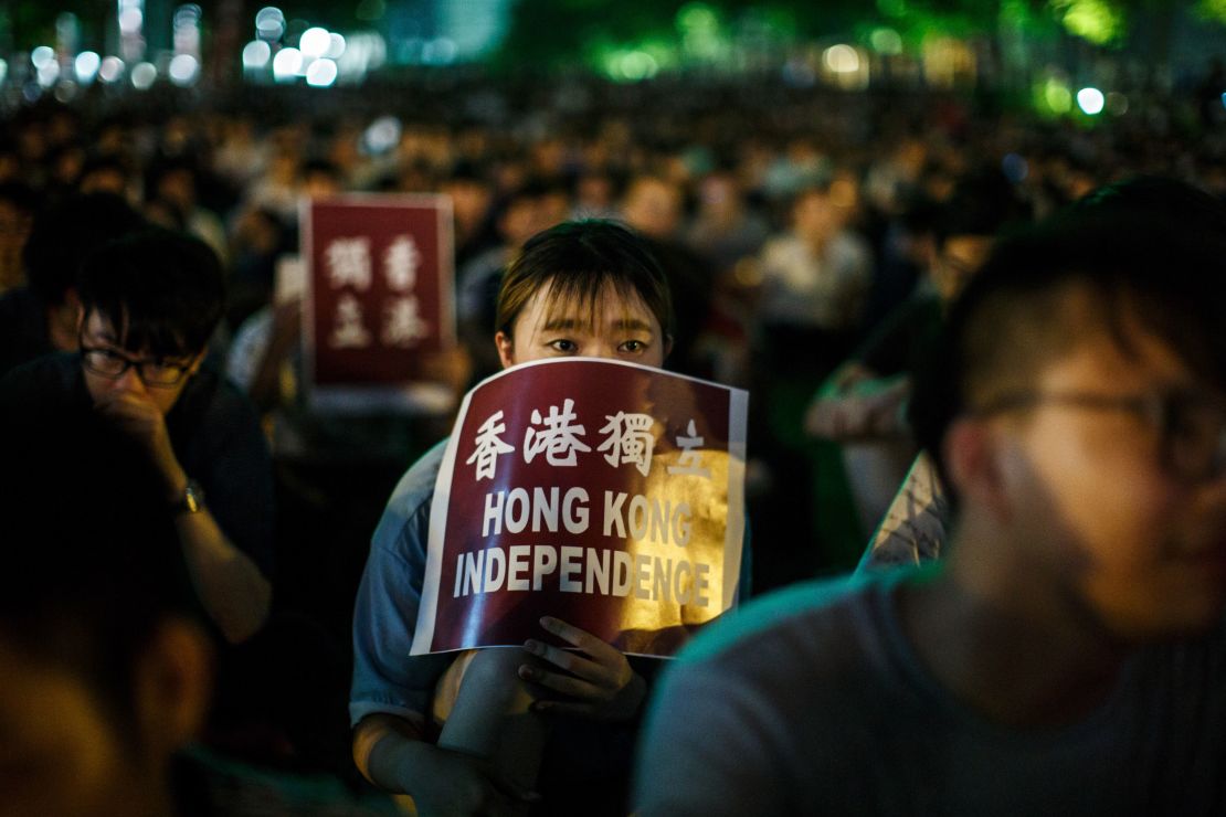 A protester holds a placard that reads "Hong Kong Independence" near the government's headquarters in Hong Kong on August 5, 2016, during the city's first pro-independence rally.
