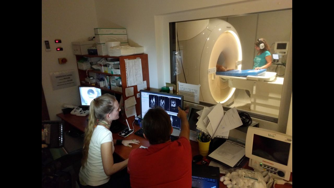 Anna Gábor (on left), Attila Andics, and Márta Gácsi (on right) -- all researchers at Eötvös Loránd University -- work around the MRI scanner during the study.