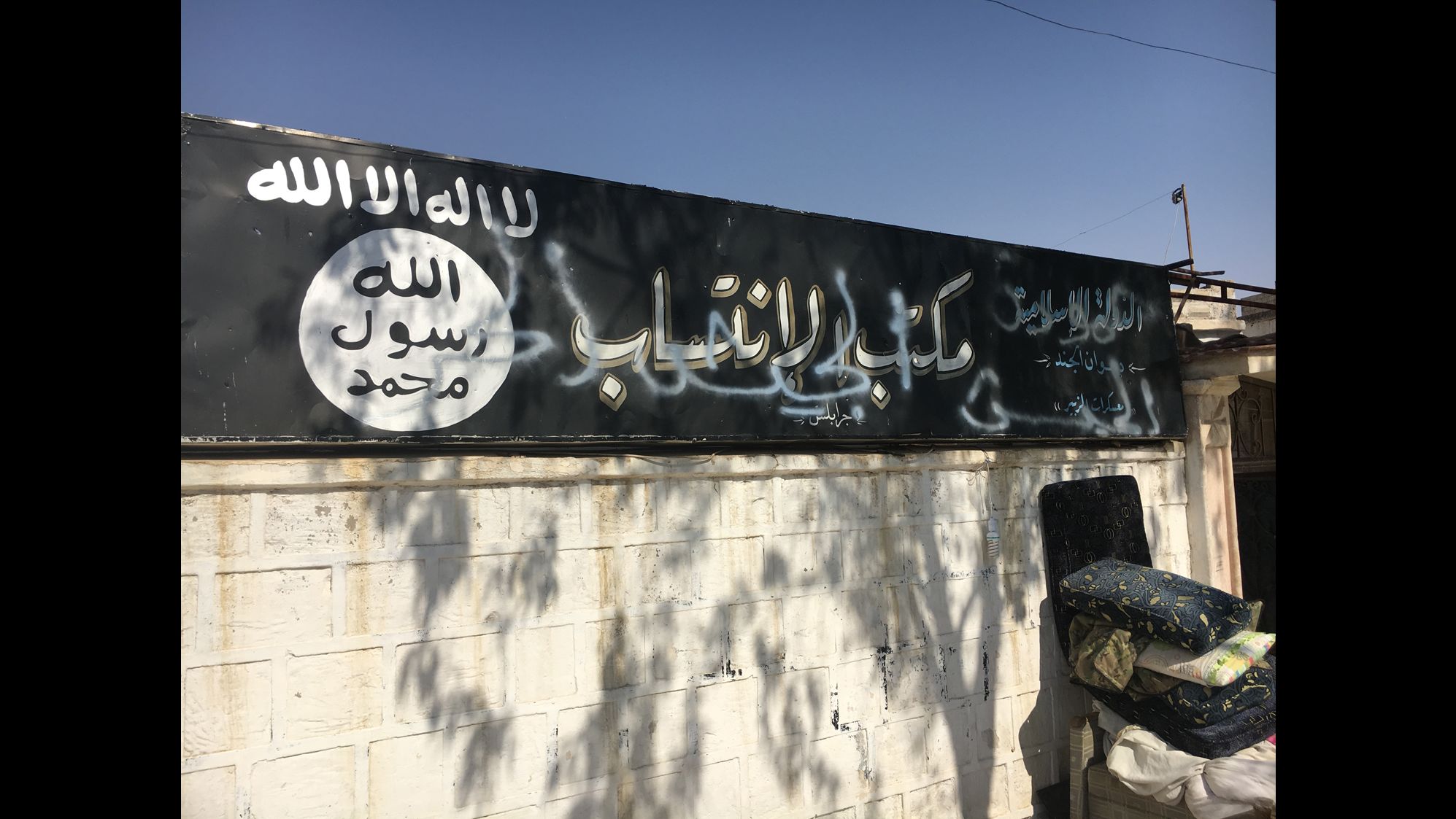 The sign in front of the ISIS recruitment center in Jarablus now has the words "Free Syrian Army" sprayed over it.