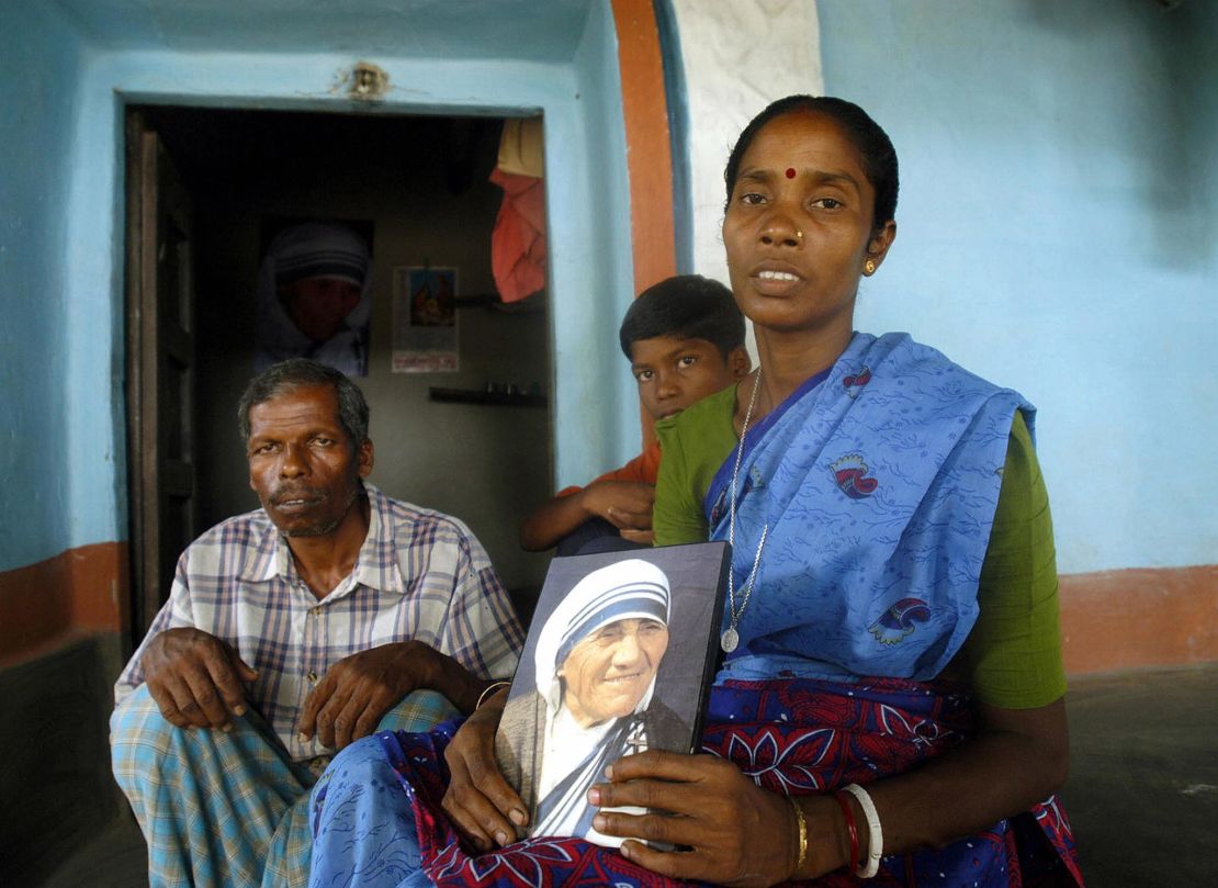 Monica Besra sits with members of her family in her home village of Nakur at Manirampur, some 450kms north of Kolkata. 