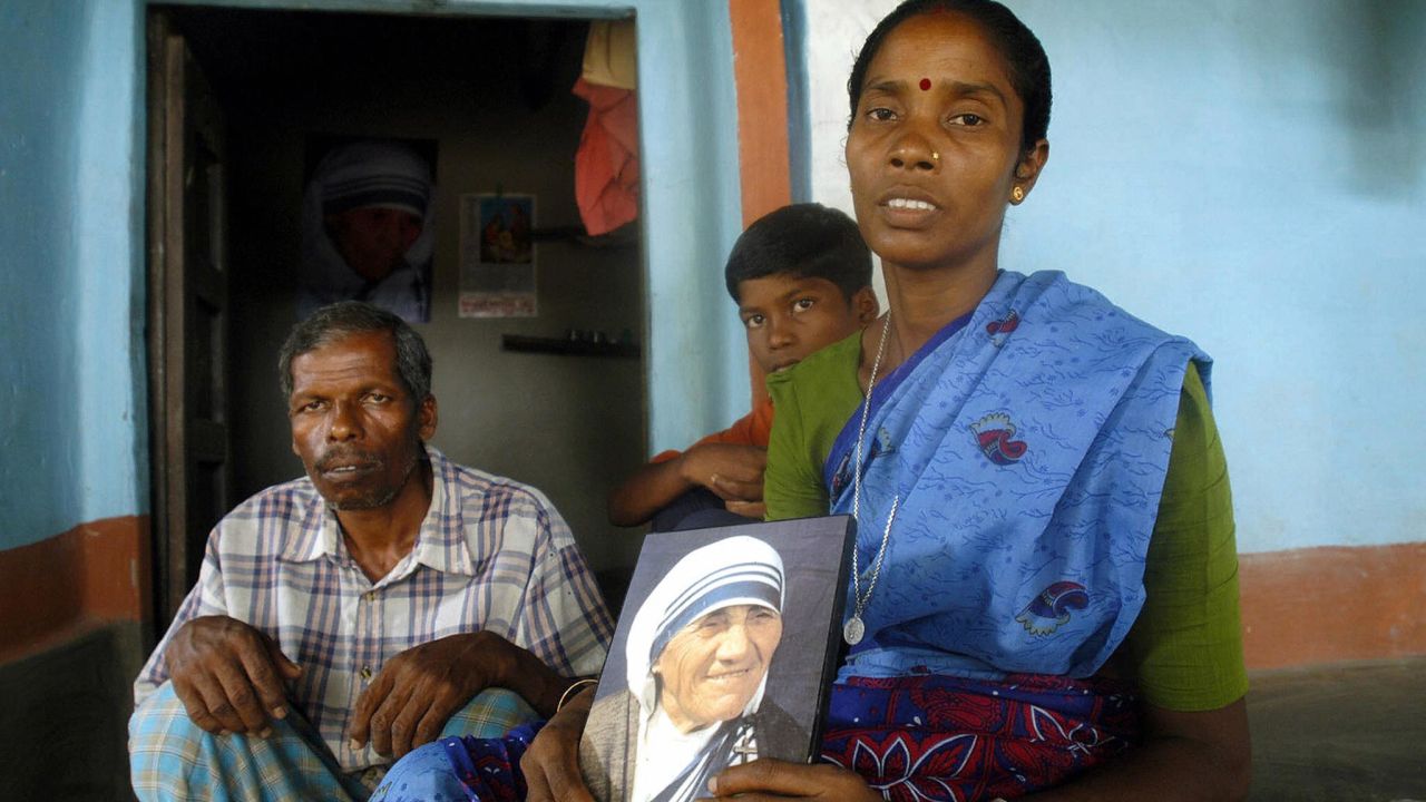 Monica Besra sits with members of her family in her home village of Nakur at Manirampur, some 450kms north of Kolkata.