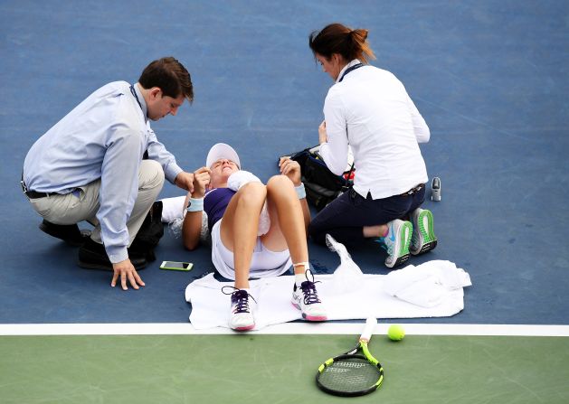 Britain's Johanna Konta, ranked 14th, needed treatment after dropping to the court. Steamy conditions seemingly took their toll but Konta ended up beating Tsvetana Pironkova 6-2 5-7 6-2.
