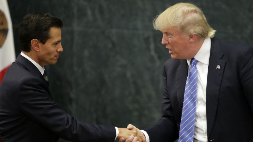 Mexican President Enrique Pena Nieto (L) and US presidential candidate Donald Trump shake hands after a meeting in Mexico City on August 31, 2016.
Donald Trump was expected in Mexico Wednesday to meet its president, in a move aimed at showing that despite the Republican White House hopeful's hardline opposition to illegal immigration he is no close-minded xenophobe. Trump stunned the political establishment when he announced late Tuesday that he was making the surprise trip south of the border to meet with President Enrique Pena Nieto, a sharp Trump critic.
 / AFP / YURI CORTEZ        (Photo credit should read YURI CORTEZ/AFP/Getty Images)
