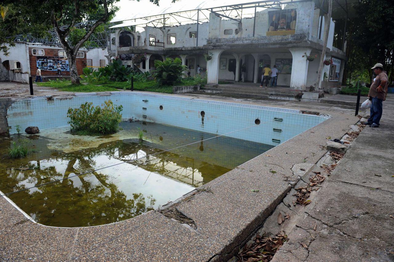 Visitors in 2009 examine what was left of Escobar's mansion, including the swimming pool. The mansion has since been demolished.