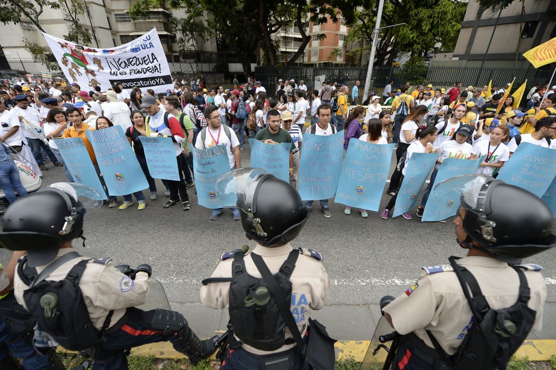 Venezuelan police face off against demonstrators before an opposition march Thursday in Caracas.