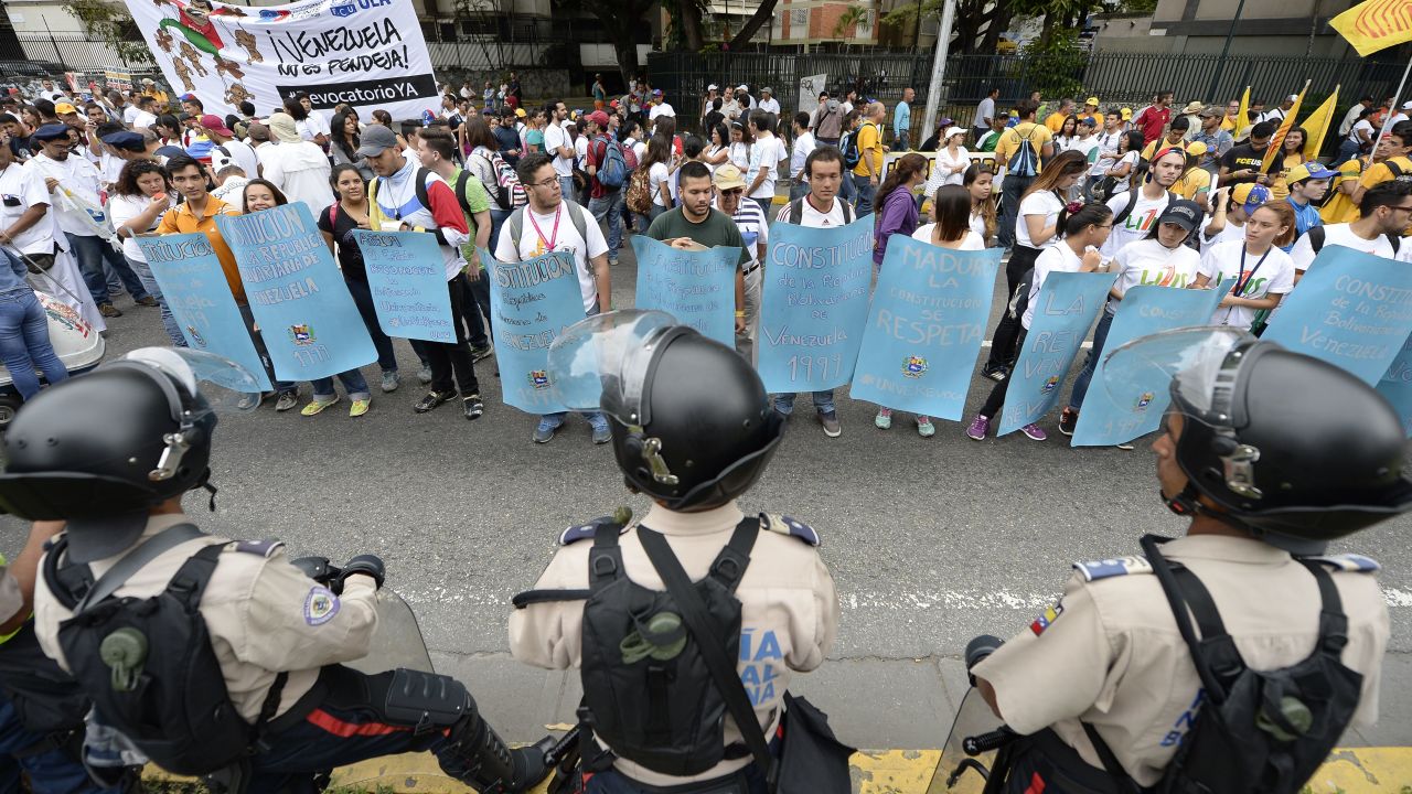 Venezuelan police face off against demonstrators before an opposition march Thursday in Caracas.