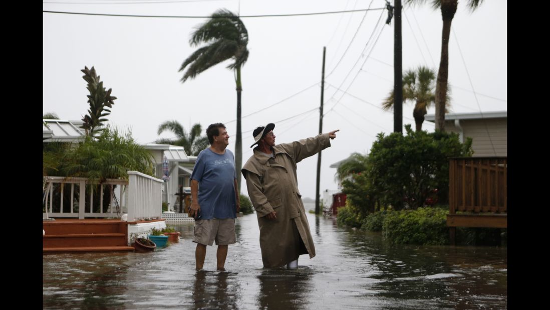 Residents of the Sandpiper Resort survey rising water in Holmes Beach, Florida, on September 1.