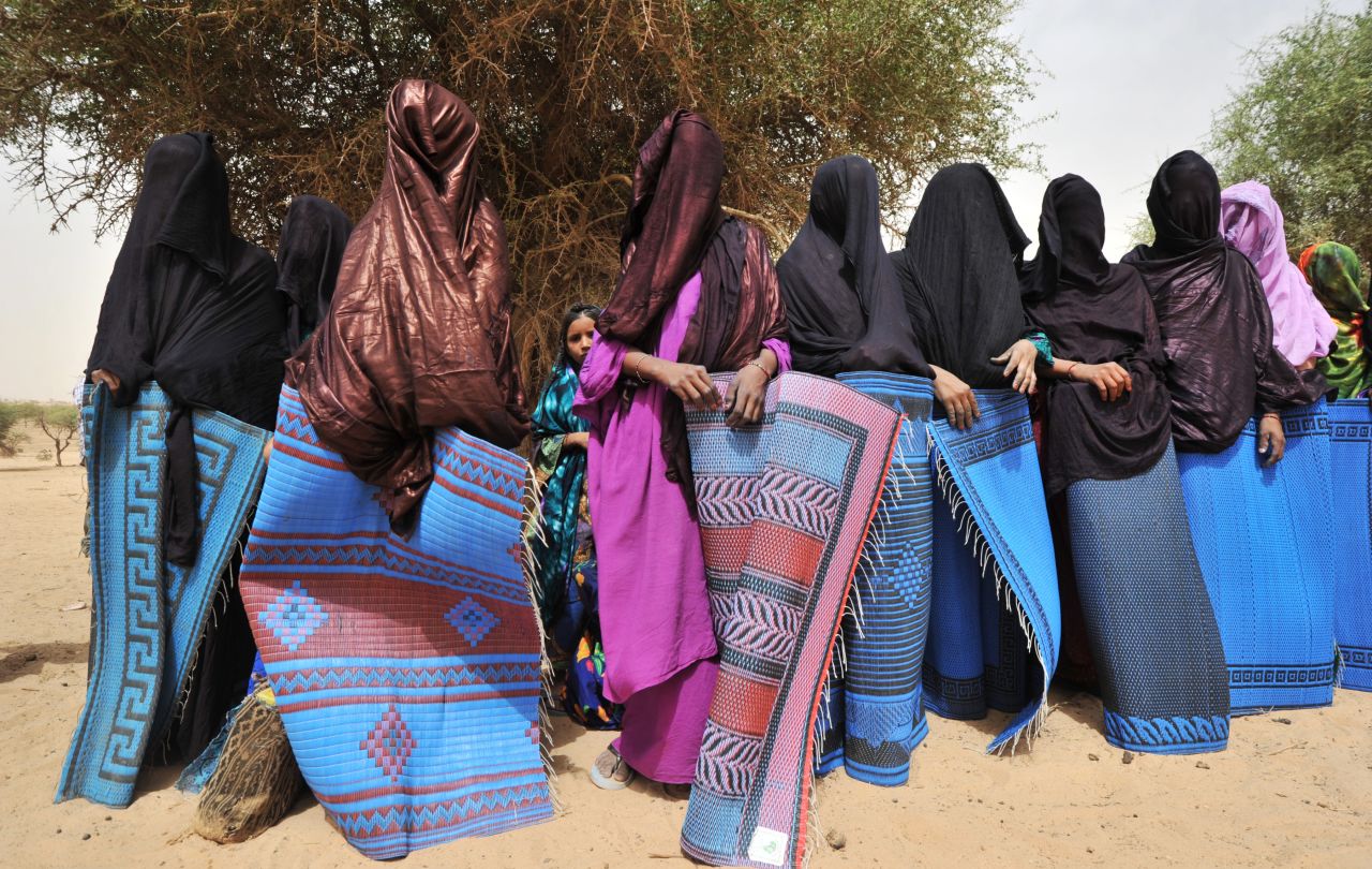 A traditional ceremony in a village near Abalak, Niger, shows veiled Tuareg women wrapped in rugs to hide their bodies from visitors' looks, according to local custom. Jubber says the Sahel region -- the semiarid belt of land south of the Sahara, to which Abalak belongs -- is the site of what he calls "the first climate change war," where disputes over resources and land rights have made life difficult for nomadic herdsmen. 
