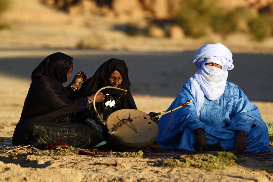 Tuareg Khoulene Alamine (center), an imzad teacher sits with a poet on the sand of the Tagmart plateau. The imzad, a single-stringed violin played only by Tuareg women, is making a comeback in Algeria. Jubber experienced a wealth of cultures that rubbed off on each other across the Sahara. "I love not only the richness of the individual cultures," he said, "but the way they intersect with each other in a matrix of interrelatedness."
