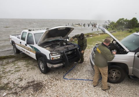 Sgt. Andy Pace and Lt. Allen Ham of the Franklin County Sheriff's Department jump-start one of their vehicles as Hermine approaches on September 1.