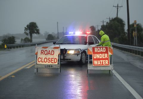 A police car blocks a flooded road that leads to Cedar Key on September 1.