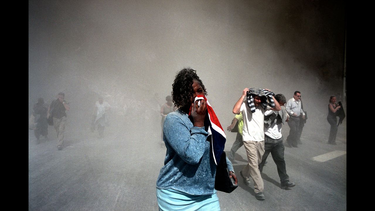 People use masks made out of clothing to protect themselves from dust after the collapse. (Gilles Peress)