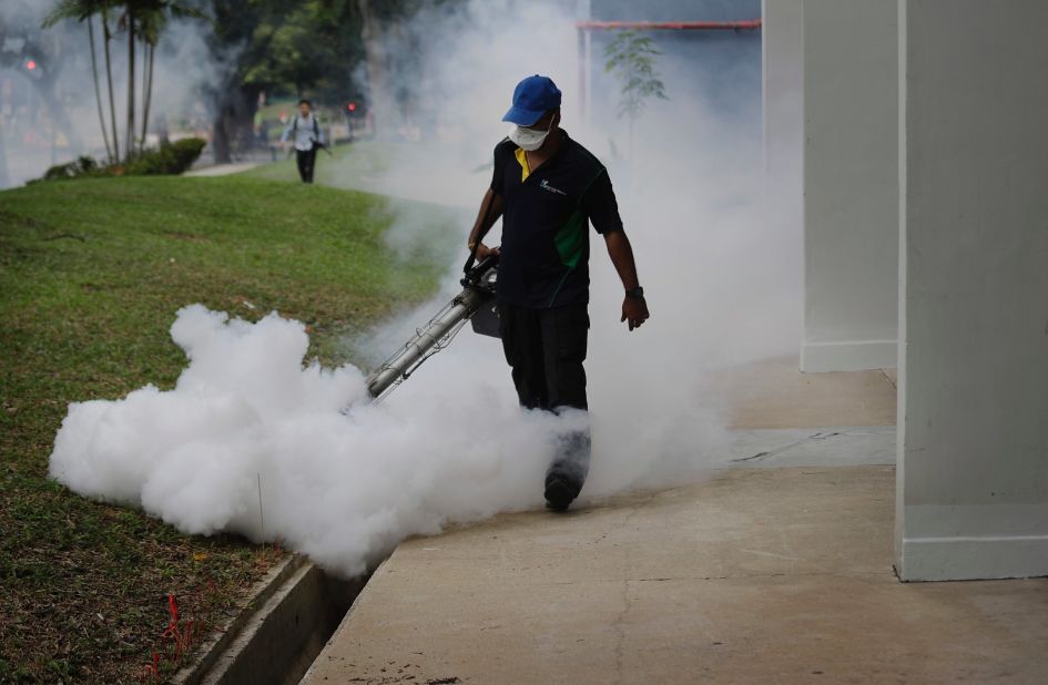 A pest control worker fumigates drains at a local housing estate where the latest case of Zika infections were reported on Thursday, September 1, in Singapore. 
