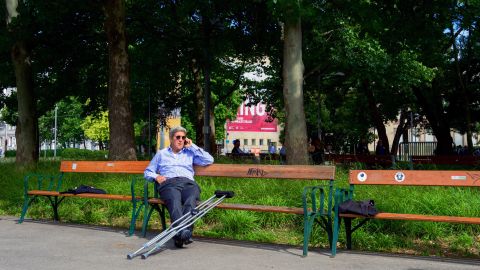 Kerry, on a park bench near the Imperial Hotel in Vienna, places a call to the president of the Dominican Republic in 2015. He needed crutches after breaking his leg in a May 2015 bike accident in France.