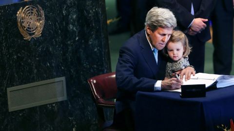 Kerry holds granddaughter Isabel Dobbs-Higginson, 2, as he signs the Paris Agreement to limit global warming in April 2016 at the United Nations. 