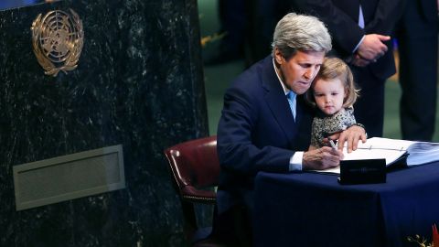 Kerry holds granddaughter Isabel Dobbs-Higginson, 2, as he signs the Paris Agreement to limit global warming in April 2016 at the United Nations.
