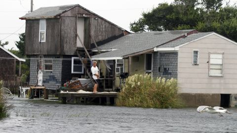 A unidentified man watches the rising water from his home in Hatteras, North Carolina, after Tropical Storm Hermine passed the Outer Banks.  