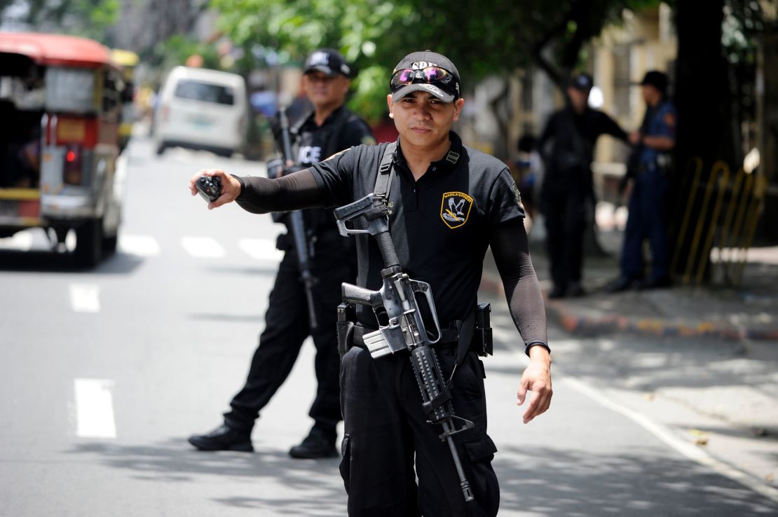 SWAT team members patrol the streets of Manila in the wake of the Davao City bombing.