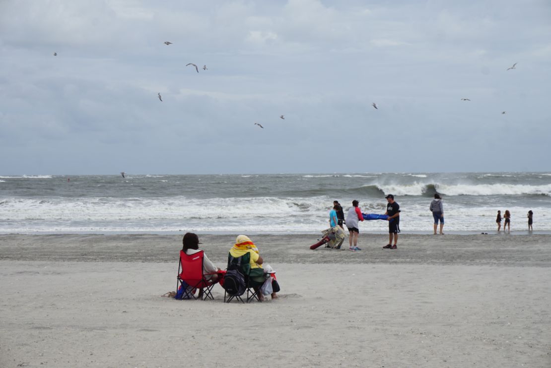 Beachgoers endure high winds and flying sand on Labor Day weekend at Atlantic City.