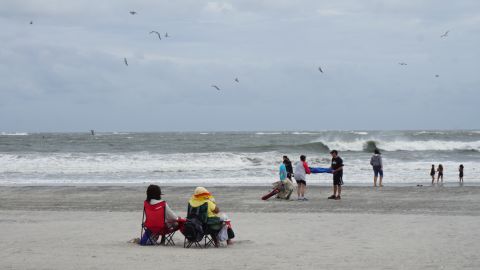 Beachgoers endure high winds and flying sand on Labor Day weekend at Atlantic City.