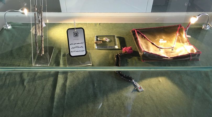 It's filled with display boxes resembling caskets, showcasing personal effects and intimate objects -- like these chains and bracelets -- found on the dead. 