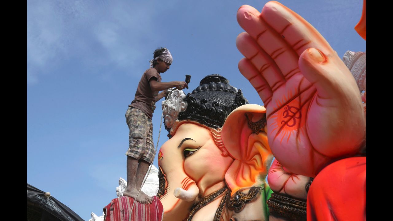 An Indian artist provides final touches to an idol of the elephant-headed Hindu god Ganesha before it is carried off for worship during Ganesh Chaturthi festival, in Hyderabad, India, on Monday, September 5. The Ganesh Chaturthi festival, a popular 10-day religious festival celebrated across India, runs this year from September 5-15 and culminates with the immersion of idols of Ganesh in the Arabian Sea and other local water bodies.