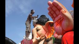 An Indian artist provides final touches to an idol of the elephant headed Hindu god Ganesha before it is carried off for worship to mark Ganesh Chaturthi festival, in Hyderabad, India, Monday, Sept. 5, 2016. The idol will be immersed in water bodies after worship at the end of the festival. (AP Photo/Mahesh Kumar A.)