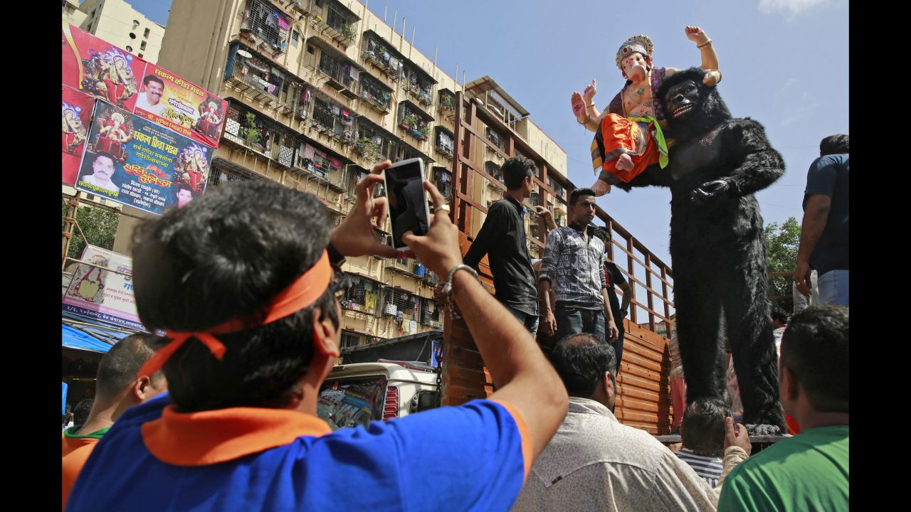 A devotee takes photos of an idol of elephant-headed Hindu God Ganesha with a likeness of a gorilla during celebrations in Mumbai, India, on September 5.