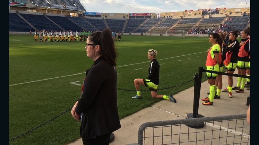 Seattle Reign midfielder Megan Rapinoe takes a knee as the national anthem is sung ahead of the Reign's match with the Chicago Red Stars.