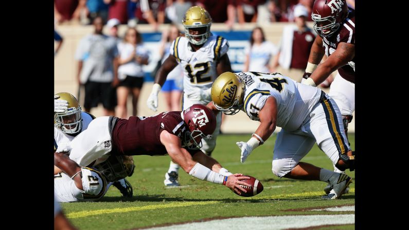 Texas A&M's Trevor Knight goes in for a one-yard touchdown during a game against UCLA in College Station, Texas, on Saturday, September 3. UCLA lost 24-31, and Texas A&M's win was one of five upsets in the first week of the college football season.