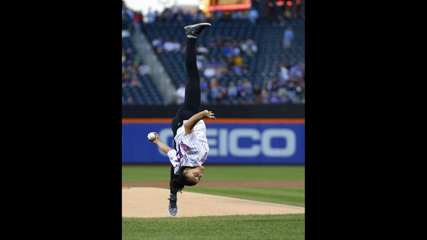 Olympic gold-medal gymnast Laurie Hernandez flips as she throws the first pitch in a game between the Washington Nationals and New York Mets in New York on Saturday, September 3. The Mets won 3-1.