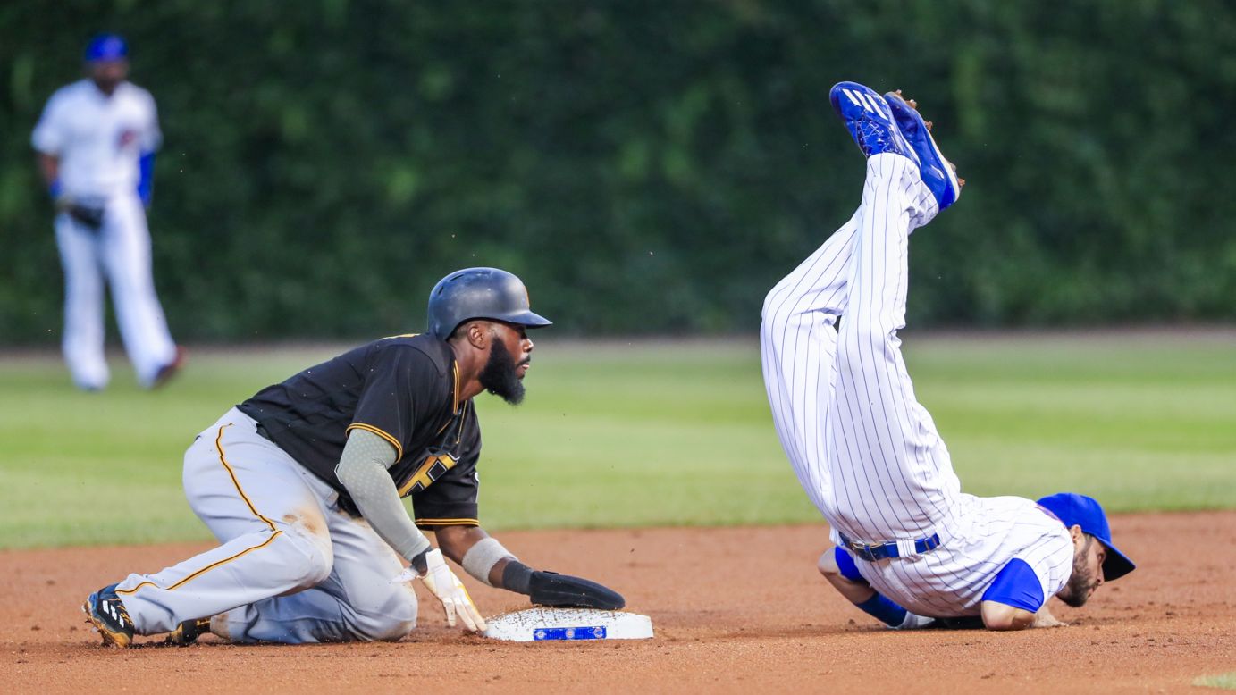 Pittsburgh's Josh Harrison, left, looks on as Tommy La Stella of Chicago falls during a game in Chicago on Wednesday, August 31. Chicago won 6-5.