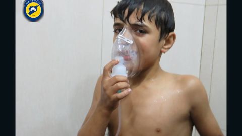 A young victim breathes through an oxygen mask at a makeshift hospital.