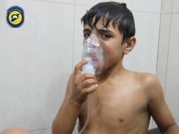 A young victim breathes through an oxygen mask at a makeshift hospital.