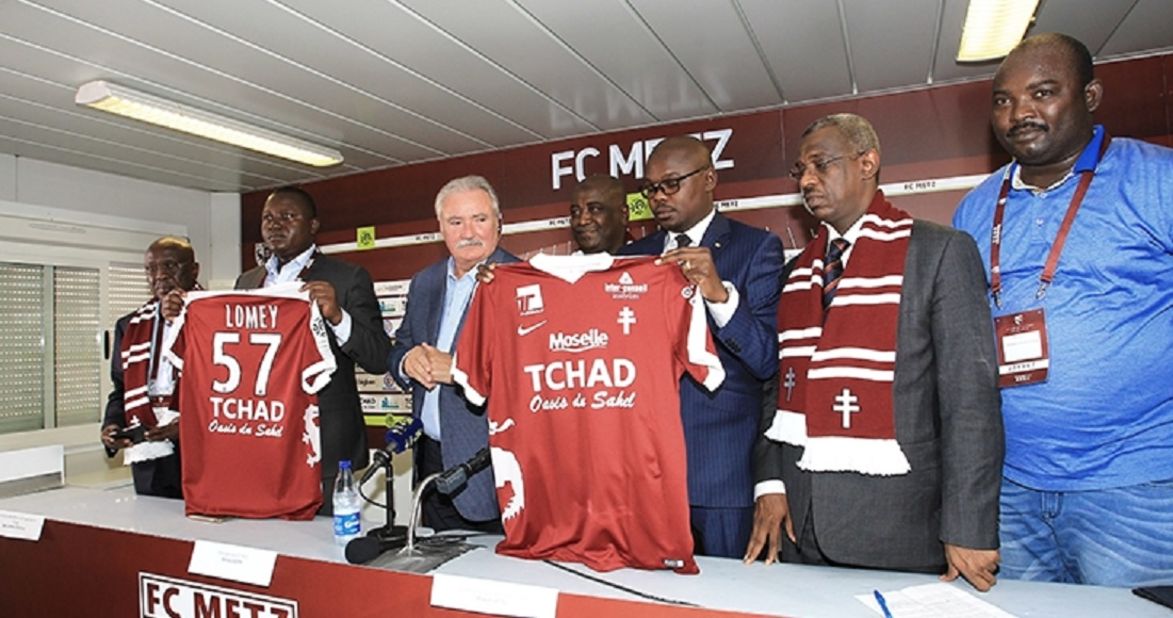 FC Metz President Bernard Serin appears with Chad Minister of Culture, Youth and Sport Betel Miarom to announce the sponsorship agreement, which will see the French club play with "Chad: Oasis of the Sahel" on the team shirts. <br /><br />Chadian officials believe the deal will improve their public image and encourage tourism to the Central African state. 