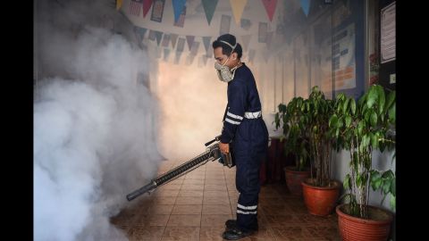 A pest control worker fumigates a school corridor on the eve of the annual national Primary School Evaluation Test in Kuala Lumpur on Sunday, September 4. Malaysia reported its first locally transmitted Zika case on September 3. 