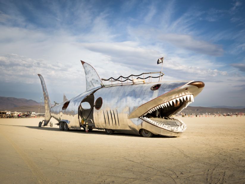 "This art car has a long history at Burning Man, first appearing in 2002. Originally created by Sid Kurz, it belongs to the Seattle-based Lodi Camp. The Shark Car has undergone many redesigns over the years. It returned with a shiny aluminum finish in 2016 but spent much of the week out of commission."