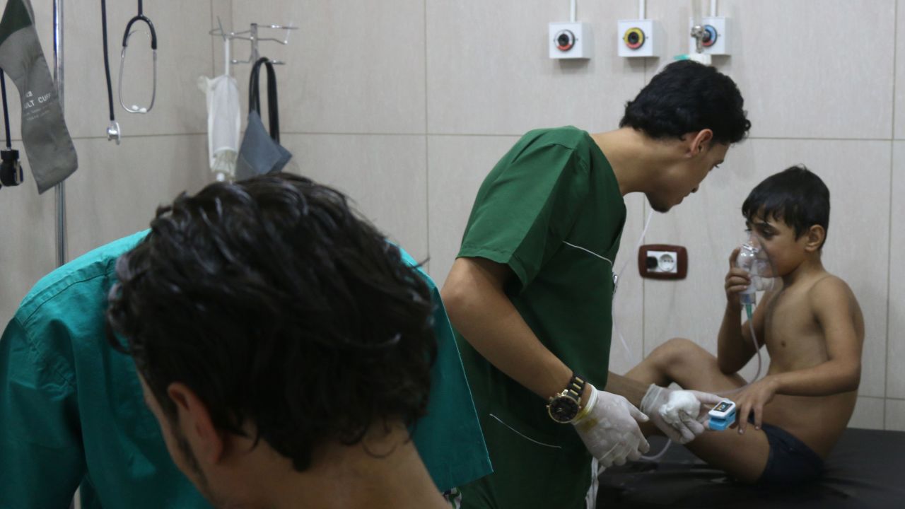 Doctors treat children after purported chlorine attack in Aleppo.