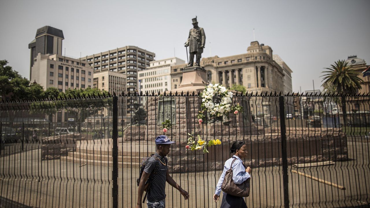 Paul Kruger's statue stands behind barbed wire in Church Square.