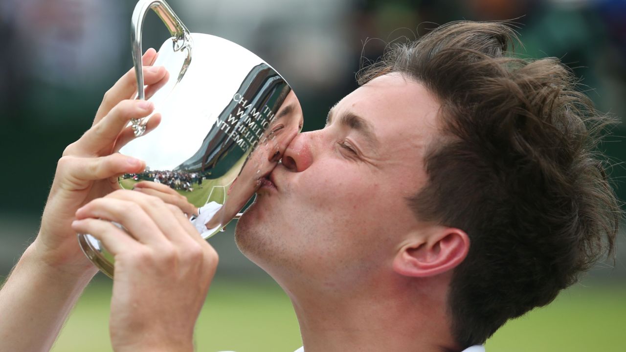 Gordon Reid kisses the winner's trophy after beating Sweden's Stefan Olsson in the wheelchair singles final match at Wimbledon.