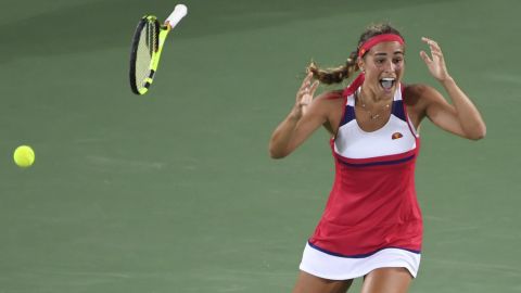 Monica Puig falls to her knees having beaten an opponent ranked 34 places above her. 