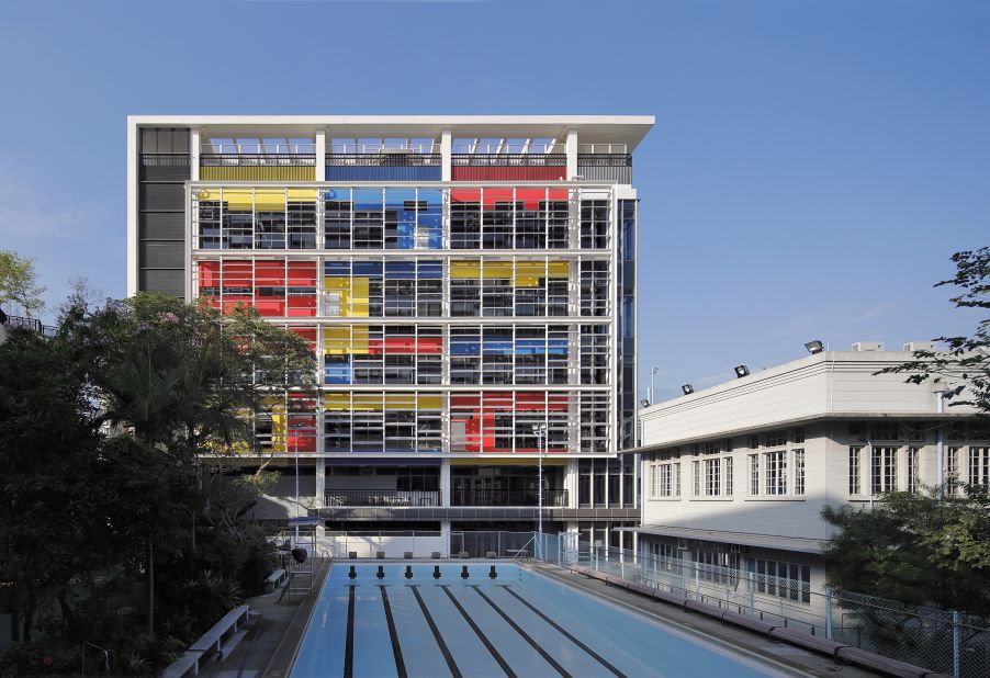 This striking redevelopment of an existing campus in high-density Hong Kong features louvered screens that improve the penetration of sunlight and ventilation, and vertical greening gardens in breakout spaces, which enlarge green areas at the school.