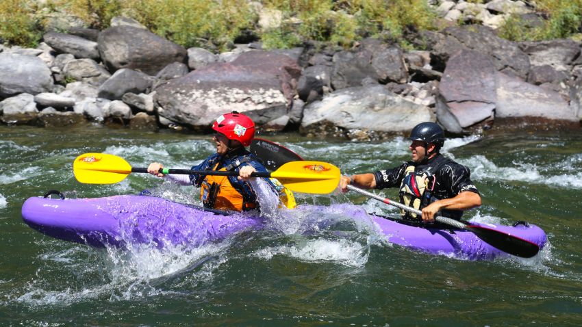 CNN Hero Brad Ludden  and First Descents participant Forest kayak in tandem