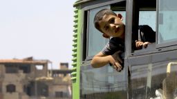 Syrian civilians from the town of Daraya are evacuated by bus from the rebel-held town of Moadamiyet al-Sham on September 2, 2016 to be taken to a shelter in the government-controlled town of Hrajela.   
More than 300 Syrians living in the opposition-held Moadimayet al-Sham district after fleeing fighting in rebel-held Daraya were evacuated under a deal, Syrian state media reported. The civilians evacuated were mostly women and children, and have been in Moadimayet al-Sham for around three years, after fleeing clashes in Daraya.
 / AFP PHOTO / LOUAI BESHARALOUAI BESHARA/AFP/Getty Images