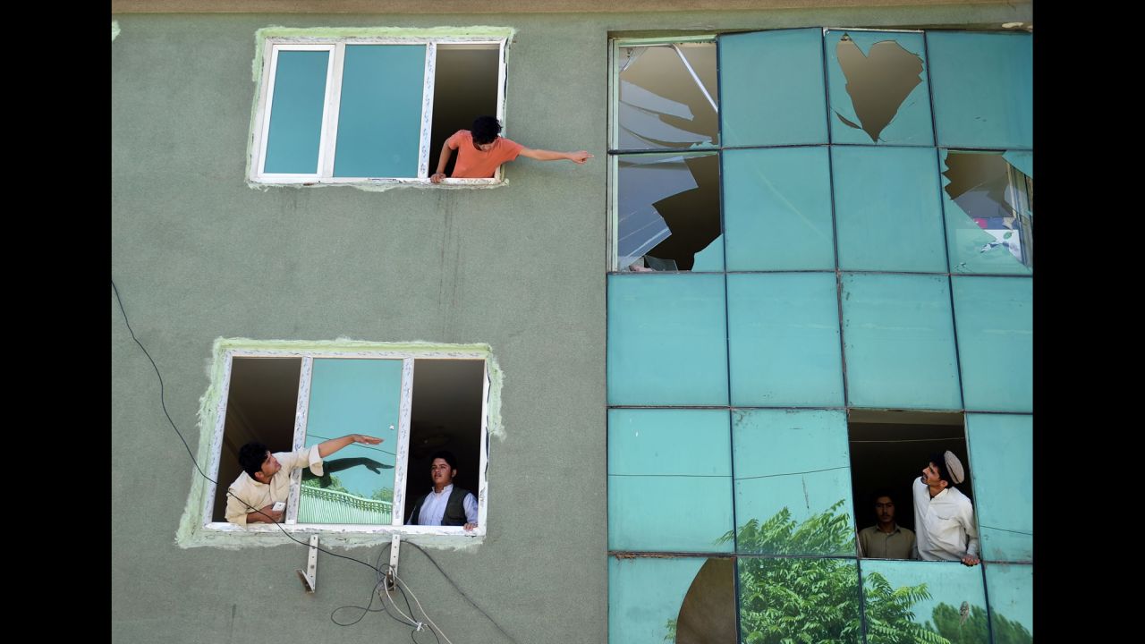 Residents look at a building's broken windows after <a href="http://www.cnn.com/2016/09/06/asia/care-kabul-ngo-attack/" target="_blank">a car bomb blast</a> near the compound of the nongovernmental organizational CARE in Kabul, Afghanistan, on Tuesday, September 6.
